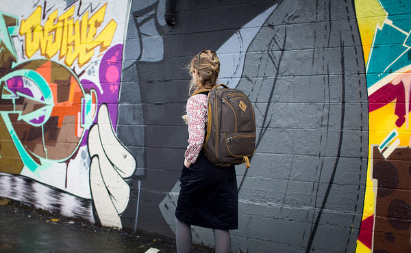 A 3/4 shot of a person with a smaller frame carrying a Synik 30.